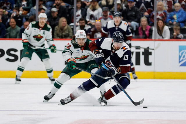 Valeri Nichushkin turns away with the puck from a Minnesota Wild defenseman.