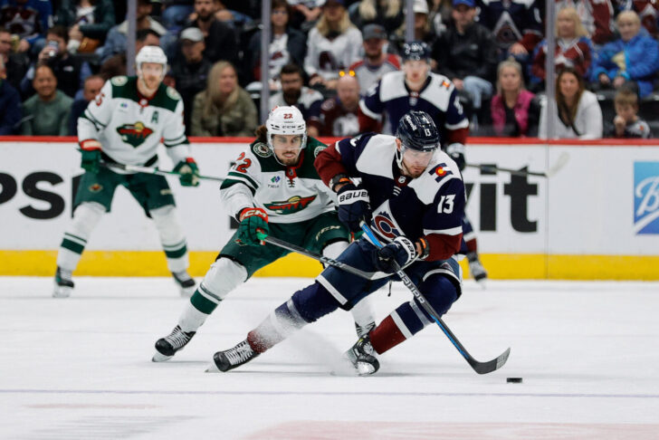 Valeri Nichushkin turns away with the puck from a Minnesota Wild defenseman.
