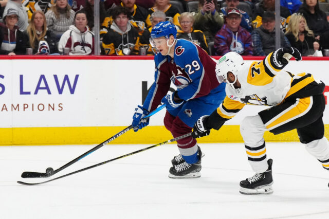 Nathan MacKinnon skates by Evgeni Malkin in a game with the Colorado Avalanche versus the Pittsburgh Penguins.